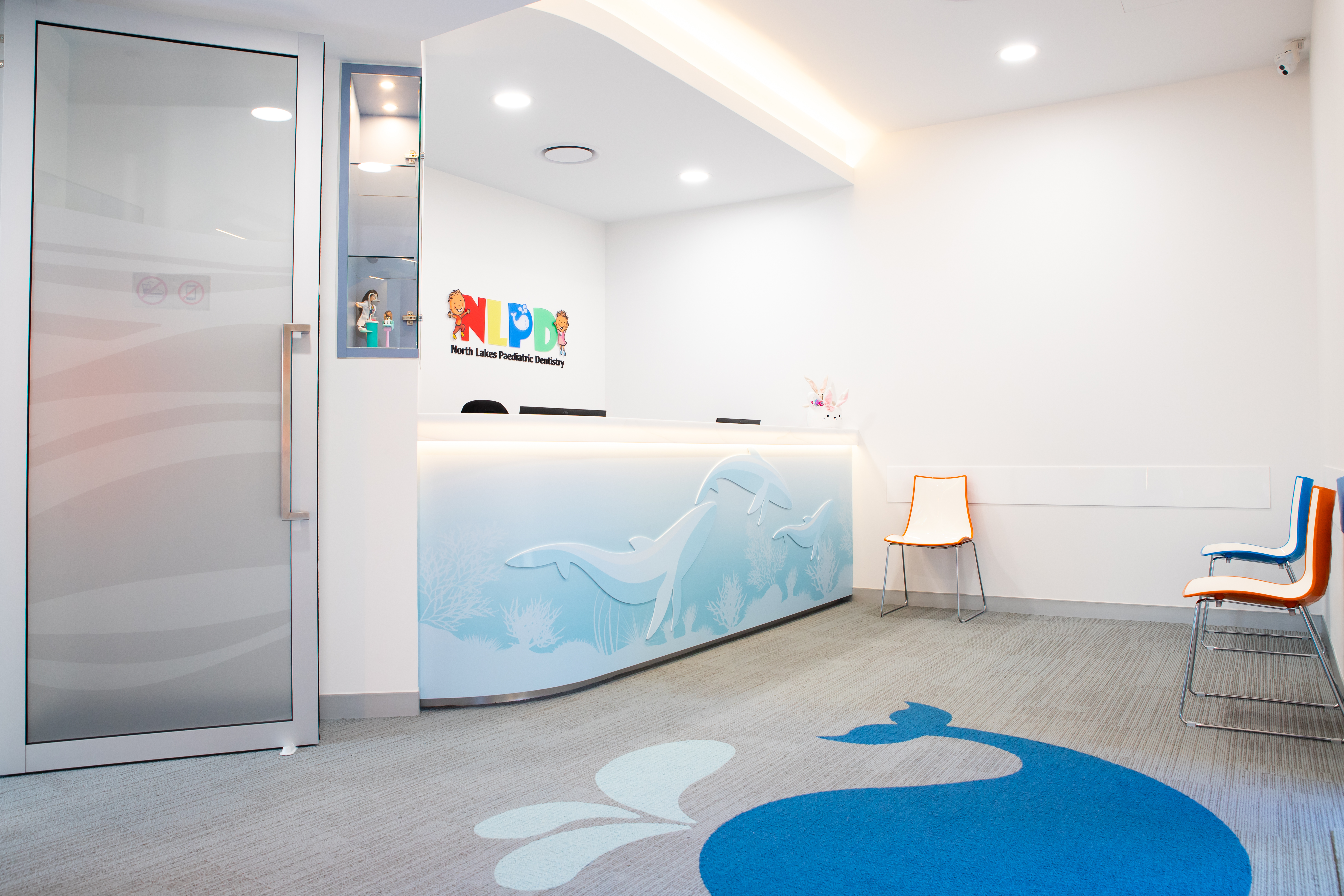 NLPD reception area featuring a whale-themed carpet design and practice signage