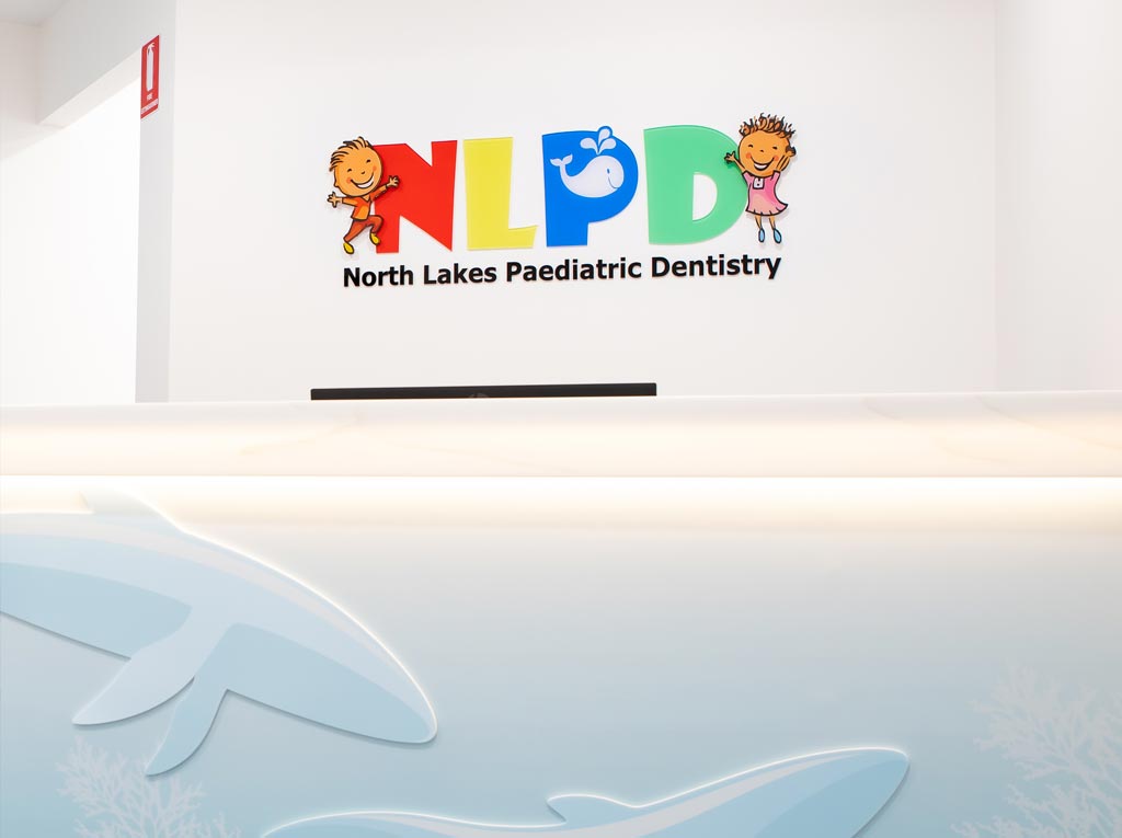 North Lakes Paediatric Dentistry reception desk with the NLPD logo on the wall
